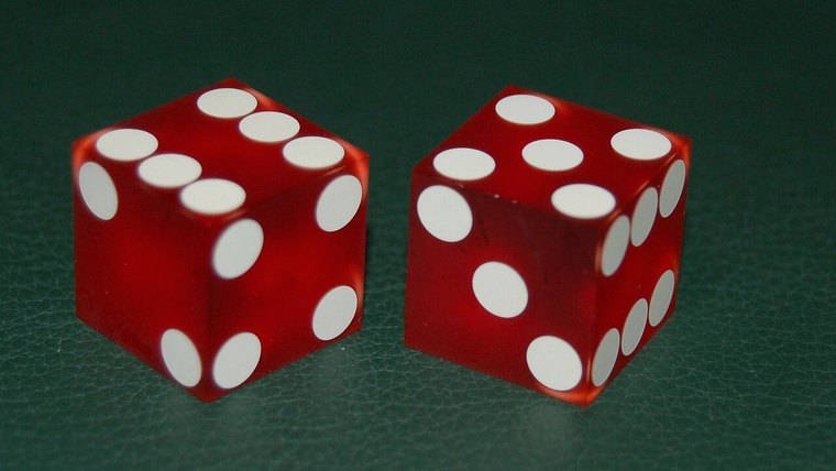 Pair of casino dice on green felt