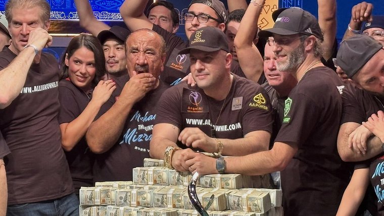 Spectators around a poker tournament table