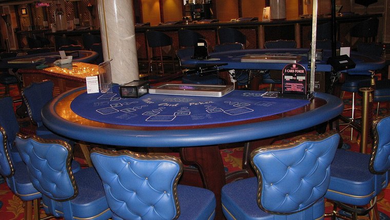 Poker table with chairs and felt layout